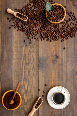 coffee background with beans and cup of americano wooden table flat lay space for textの写真素材