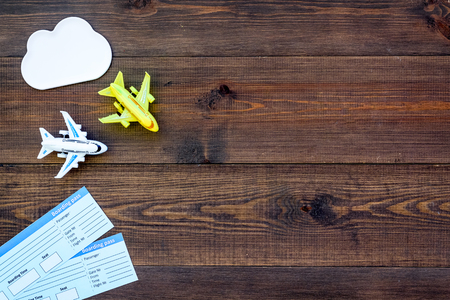 Planning trip with child with tickets and toys wooden background top view space for textの写真素材