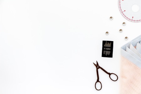Tailor shop with thread, scissors, fabric. Sewing as hobby. White background top view mockupの写真素材