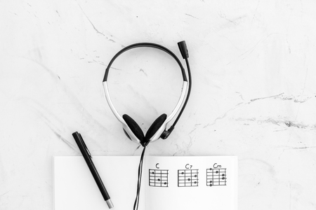 Songwriter or dj work place with notes and headphones on marble background top view mock upの写真素材