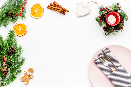 Christmas dinner decoration with gift box, plate and fir tree white table background top view mock-upの写真素材