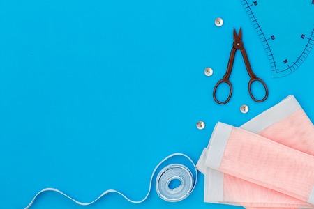 Hobby sewing with thread, scissors, fabric. Lifestyle. Blue background top view mock upの写真素材