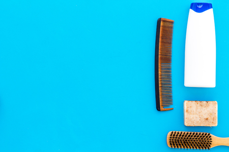 Instruments of male hairdresser with shampoo and comb in barbershop top view on light blue background mock upの写真素材
