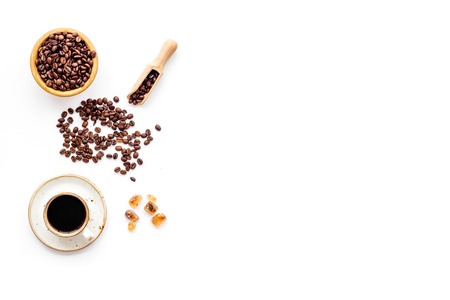 Coffee concept. Roasted beans, cup of espresso on white background top view copy spaceの写真素材