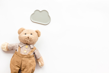 Toys for newborn baby set with teddy bear and clouds on white background flat lay space for textの写真素材