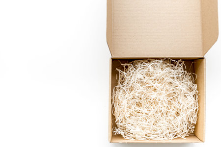 E-commerce. Delivery of goods that was purchased online. Empty cardboard box with cut paper on white...