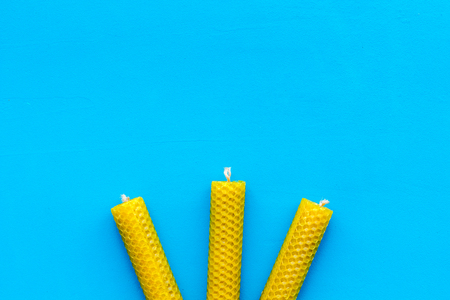 Buddhism. Candles for spiritual practice on blue background top view.の写真素材