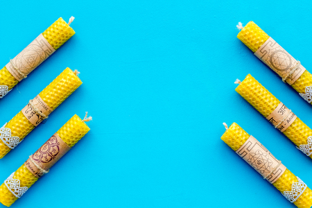 Buddhism. Candles with Yantras and mantras in Sanskrit on blue background top view pattern copy spaceの写真素材