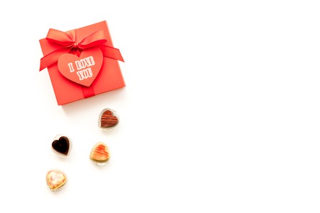 Gift for Valentines day. Gift box with text I love you and heart-shaped sweets on white background top view copy spaceの写真素材