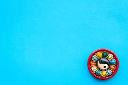 Buddhist symbol. Yin Yang symbol on blue background top view space for textの写真素材