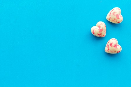 Heart-shaped confection for Valentines day on blue background top view space for textの写真素材