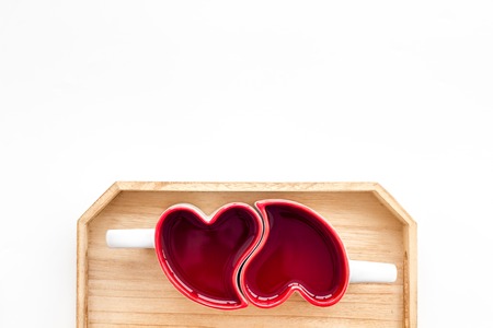 Valentines day concept. Heart-shaped mugs on white background top view space for textの写真素材