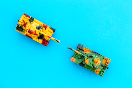 War concept. Tanks toy on blue background top view.の写真素材