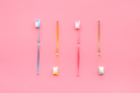Oral hygiene. Plastic toothbrushes on pink background top view.の写真素材