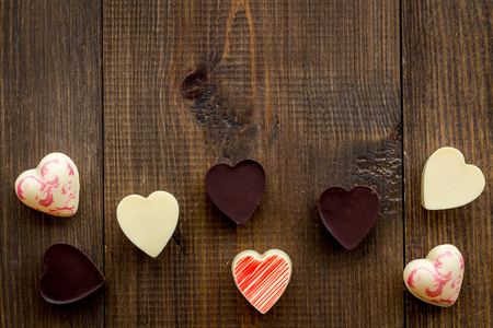 Heart-shaped confection for Valentine's day on dark wooden background top view,の写真素材