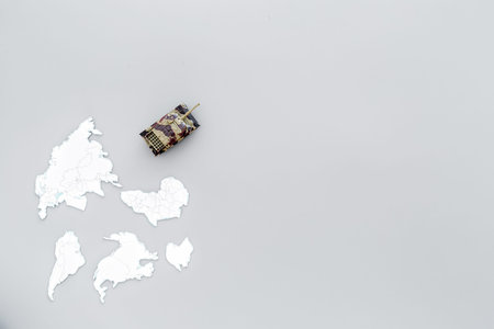 Military action, military threat concept. Tanks toy on world map on grey background top view copy spaceの写真素材