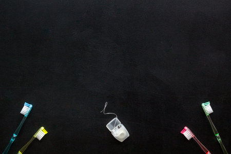 Oral hygiene. Plastic toothbrushes on black background top view space for textの写真素材