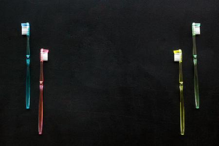 Oral hygiene. Plastic toothbrushes on black background top view space for textの写真素材