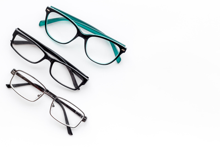 Set of glasses with transparent lenses on white background top view space for textの写真素材