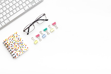 Office desk in order. Geometry. Computer keyboard and office supplies, glasses on white background top view space for textの写真素材