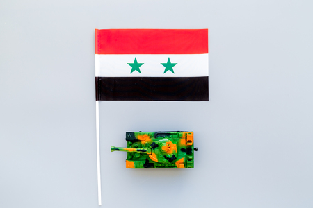 War, military threat, military power concept. Syria. Tanks toy near Syrian flag on grey background top view copy spaceの写真素材