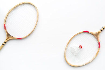 Badminton concept. Badminton rackets and shuttlecock on white background top view copy space pattern