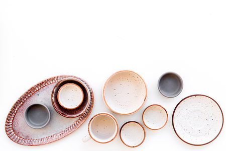 Ceramic tableware pattern. Empty plates and mugs on white background top view copy spaceの写真素材