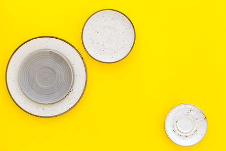 Ceramic plates pattern on yellow background top view space for textの写真素材
