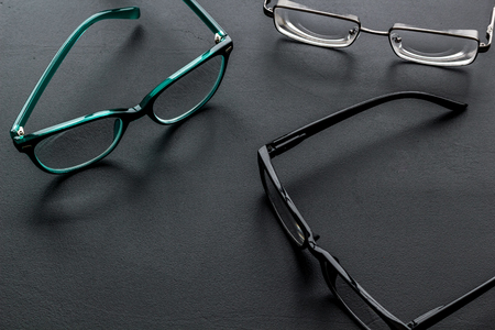 Accessories for eyes. Glasses with transparent lenses and different frames on black backgroundの写真素材