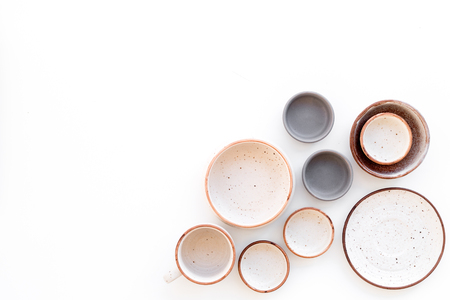 Ceramic tableware pattern. Empty plates and mugs on white background top view.の写真素材
