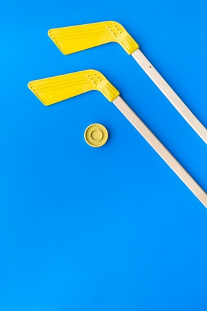 Ice hockey stick and puck on blue background top view.の写真素材