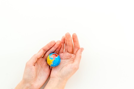 SOS Save the planet concept. The earth in hands on white background top view flat lay copy space