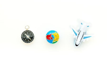 SOS Save the planet concept with the earth, plane and compass on white background top view flat lay space for text.の写真素材