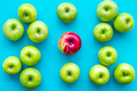 Green apples for organic summer food and fruit pattern on blue background top view