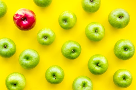 Organic food pattern with green apples on yellow background top viewの写真素材