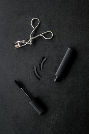 Female desk with decorative organic cosmetic on black background flatlayの写真素材
