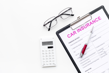 Car insurance form near glasses, calculator, pen on white background top view.の写真素材