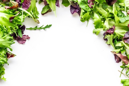 Organic food pattern with green and red salads mix on white background top view space for textの写真素材