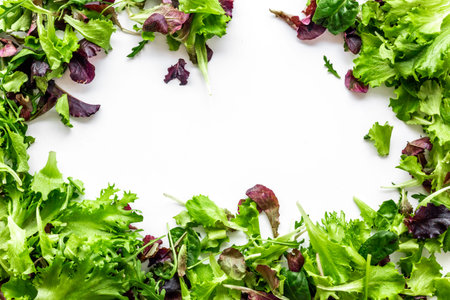 Organic food pattern with green and red salads mix on white background top view space for text