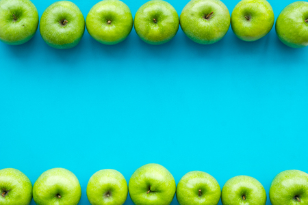 Green apples for organic summer food and fruit pattern on blue background top view mockupの写真素材
