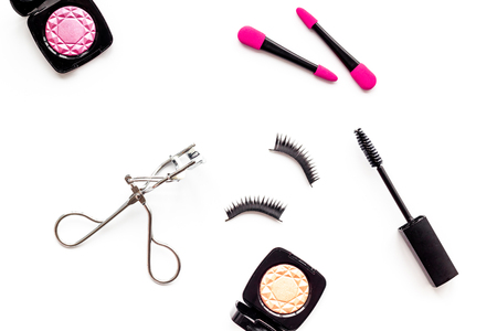 Organic decorative cosmetic set with lash curler and mascara on white woman desk background top view.の写真素材