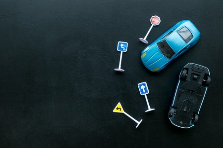 Car insurance concept with car toys on black desk background top view copyspaceの写真素材