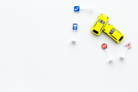 Car insurance concept with car toys on white desk background top view copyspaceの写真素材
