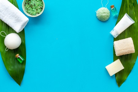 Herbal cosmetic set for homemade spa on blue women desk background top view space for textの写真素材