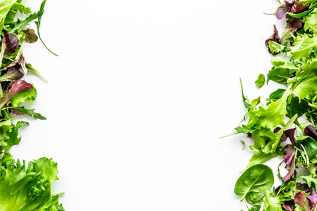 Organic food pattern with green and red salads mix on white background top view space for textの写真素材
