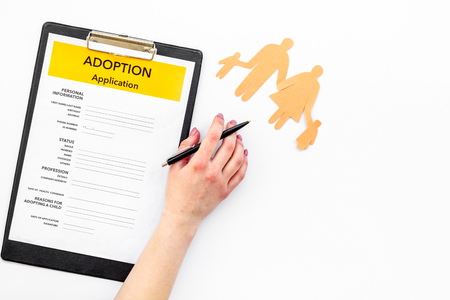Adoption application near family figures on white table background top view copyspaceの写真素材