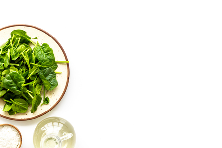 Green salad mix on plate with salt for healthy food on white background top view mock upの写真素材