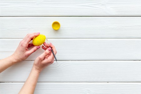 Paint eggs for Easter celebration on white wooden background top view mock upの写真素材