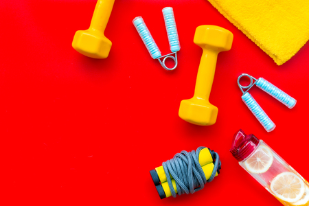 Fitness background with sport equipment for gym and home on red background top view copyspaceの写真素材