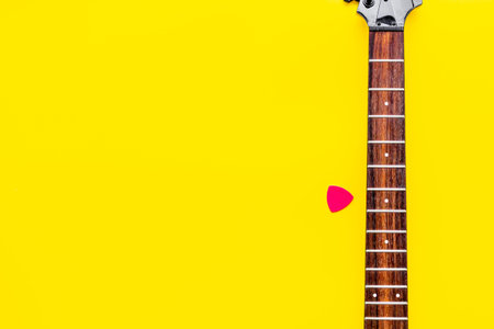 Musician work place with guitar on yellow background top view mock up.